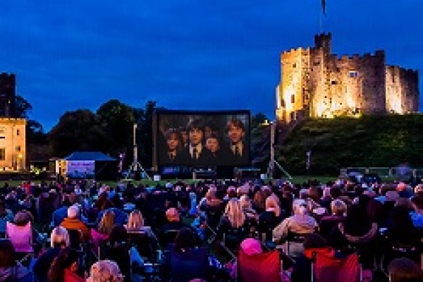Families enjoying outdoor Cinema at Cardiff Castle, including Harry Potter