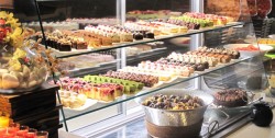 The image of this family friendly restaurant shows the deserts counter, with a selection of jummy looking gateaux