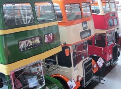 Places to visit Manchester - 3 vintage buses, green orange and red