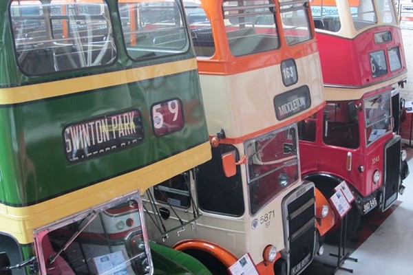 Places to visit Manchester - 3 vintage buses, green orange and red