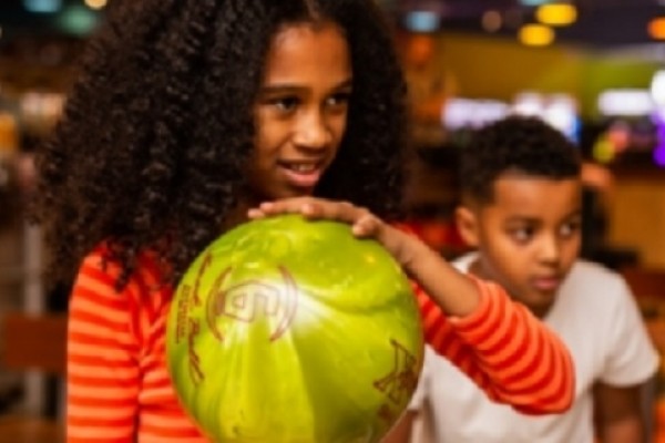 Mum holding bowl while son looks out on their Plymouth day out