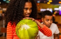 Mum holding bowl while son looks out on their Plymouth day out