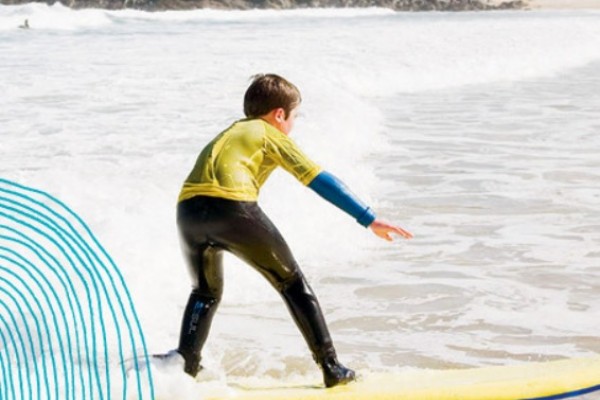 Kids Days Out in Cornwall - image of boy surfer riding the waves